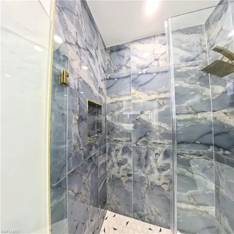 Full bathroom featuring a marble finish shower