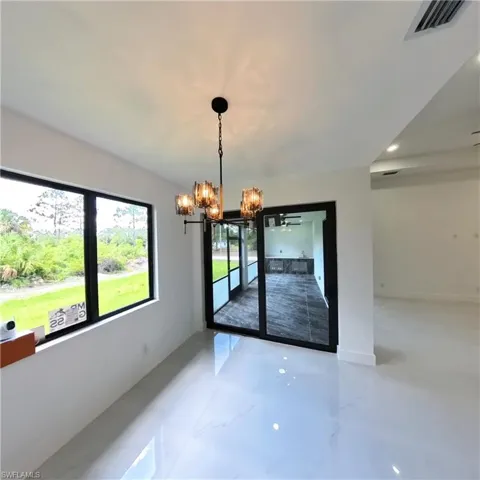 Unfurnished dining area featuring a chandelier