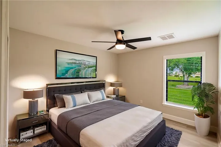 Bedroom with light hardwood / wood-style flooring and ceiling fan