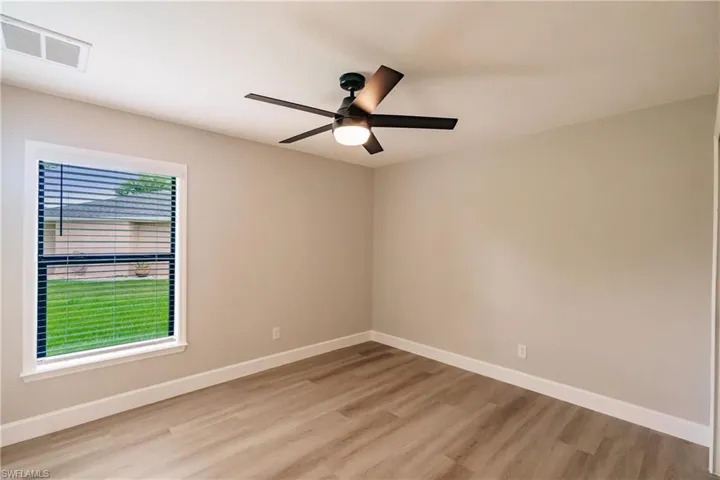 Spare room with light hardwood / wood-style floors and ceiling fan