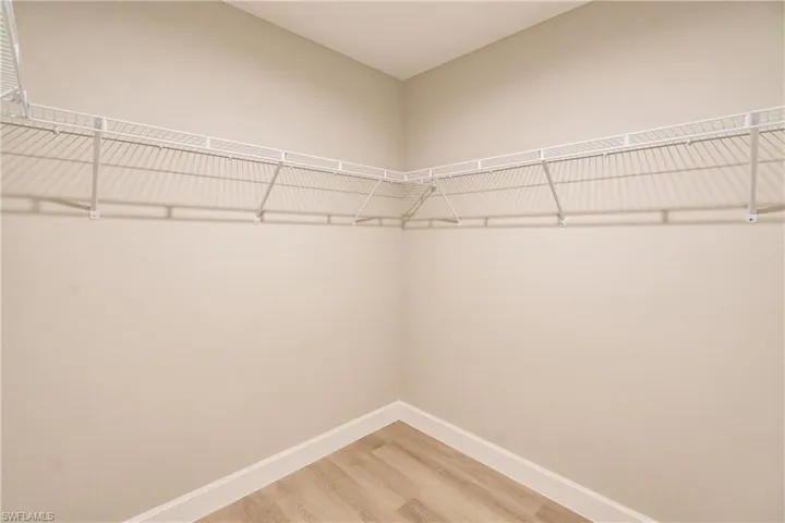 Spacious closet featuring hardwood / wood-style floors