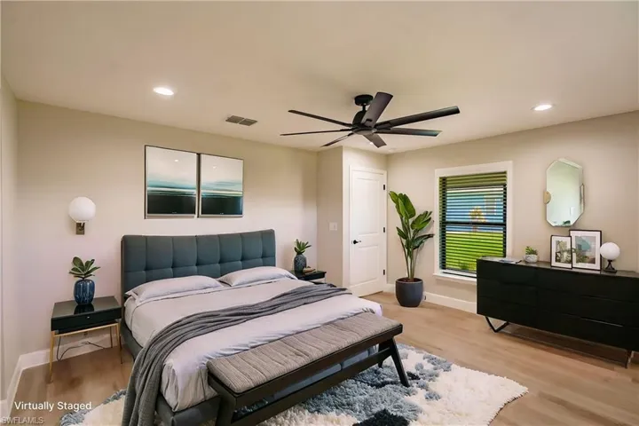 Bedroom with light hardwood / wood-style flooring and ceiling fan