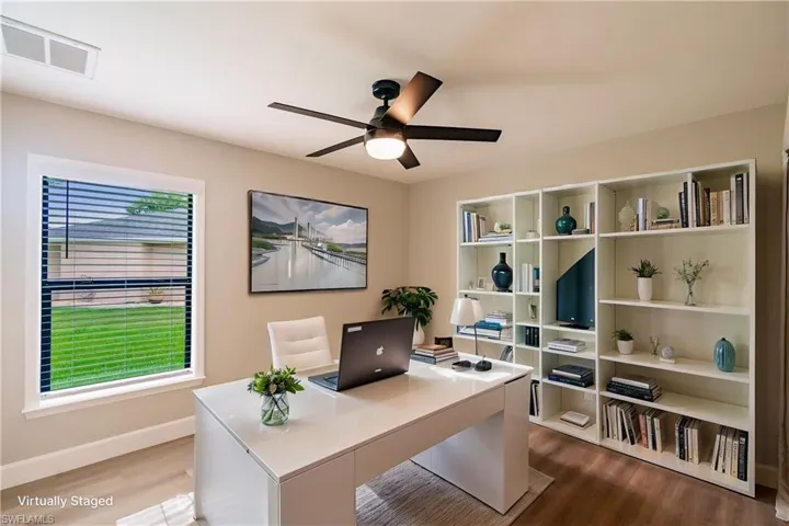 Office space featuring hardwood / wood-style floors, a healthy amount of sunlight, and ceiling fan