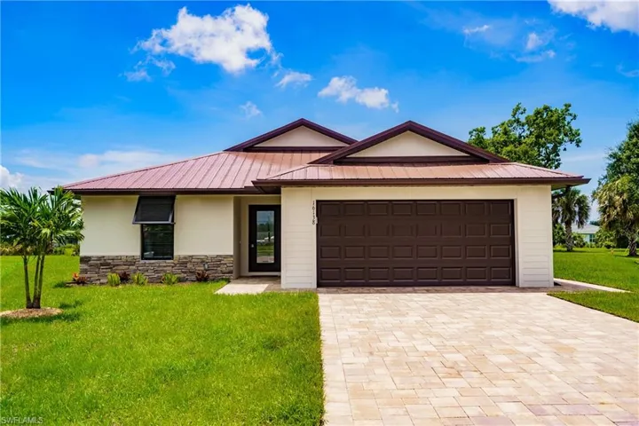 Single story home with a front yard and a garage