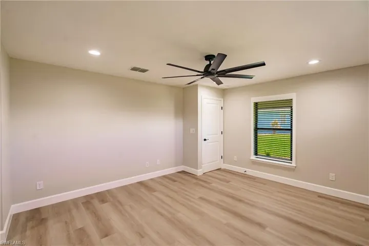 Spare room featuring ceiling fan and light hardwood / wood-style flooring