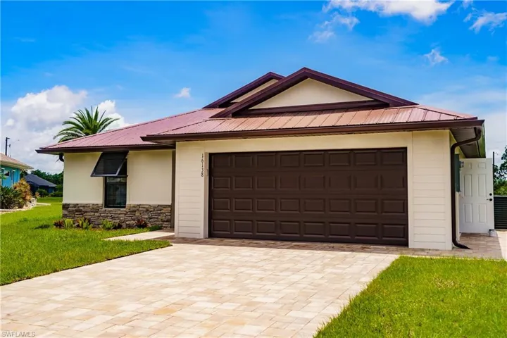 Single story home featuring a front lawn and a garage