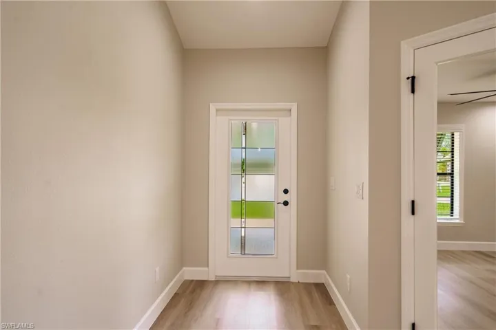 Doorway to outside with light wood-type flooring