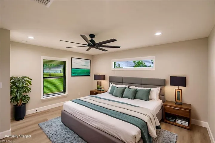 Bedroom featuring ceiling fan and light hardwood / wood-style flooring