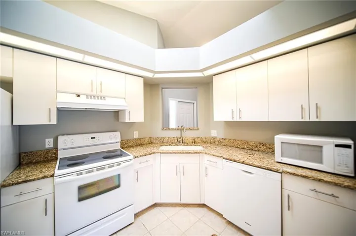This Kitchen Comes With Granite Countertops, White Appliances, White Cabinets, A Large Walk-In Pantry, And A Skylight!