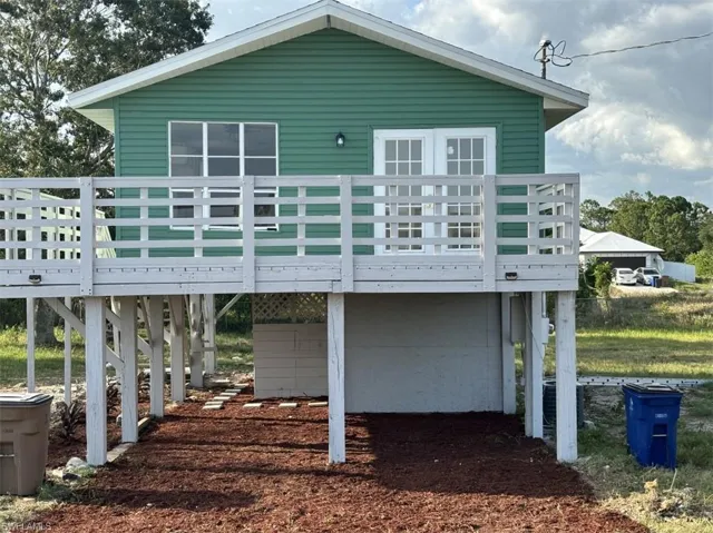 Back of house with a wooden deck