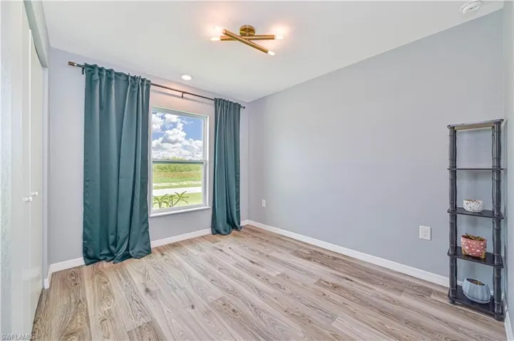 Empty room with light hardwood / wood-style floors
