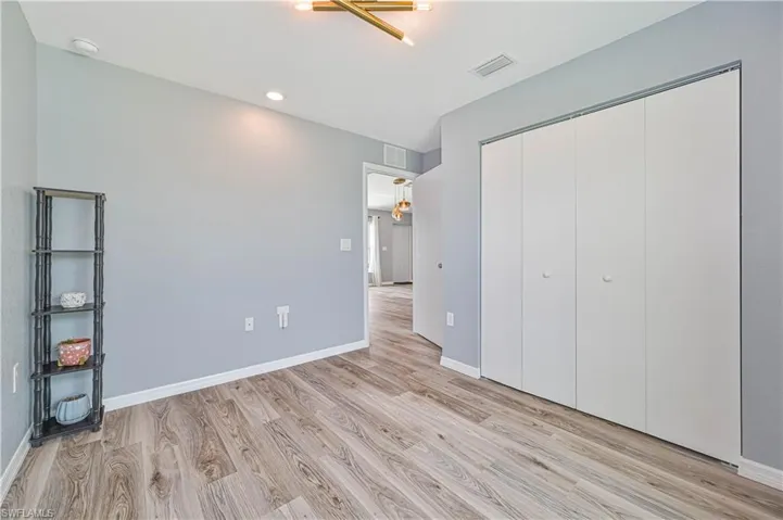 Unfurnished bedroom featuring a closet and light wood-type flooring