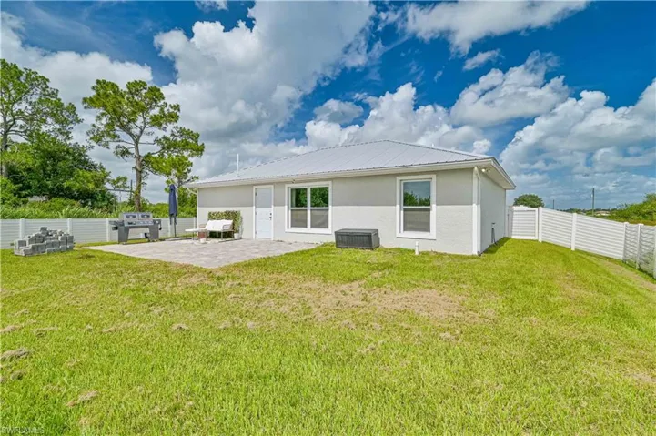 Back of house featuring a patio area, shed and fenced yard.