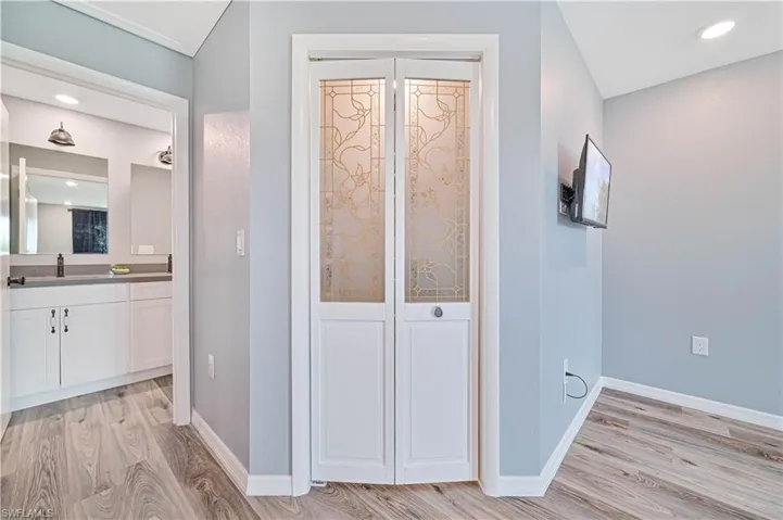 Hall featuring sink and light wood-type flooring