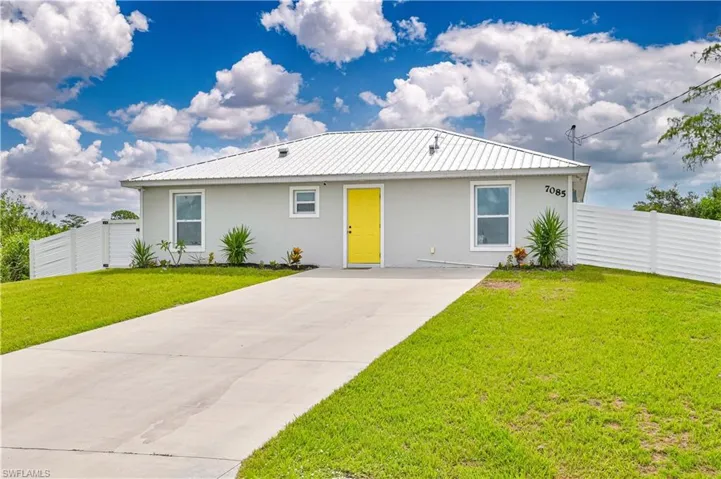 Single story home with a front lawn