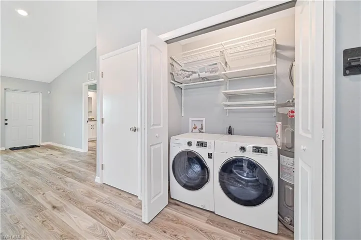 Washroom featuring electric dryer hookup, hookup for a washing machine, washer and dryer, and light wood-type flooring