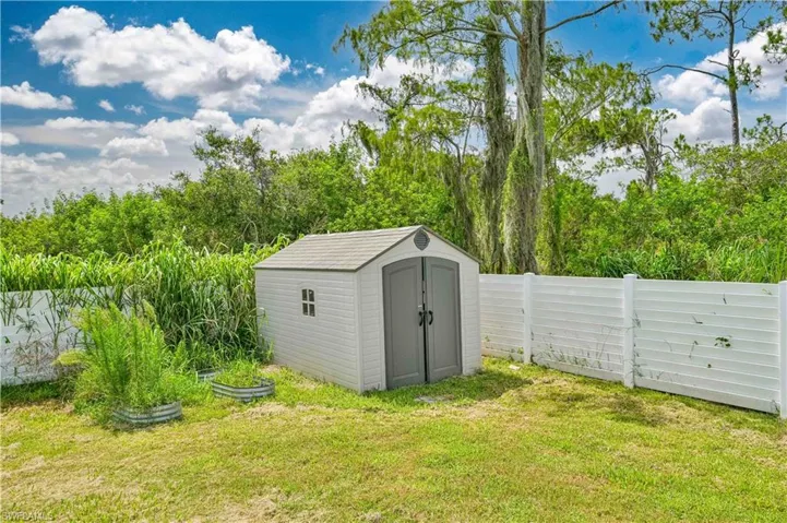View of outdoor structure with a yard
