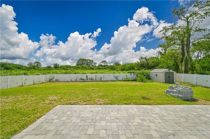 View of yard featuring a patio and a storage shed