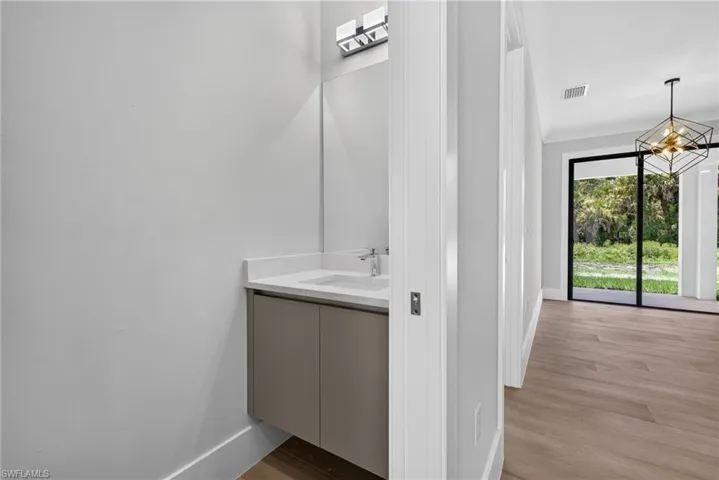 Floating vanity with integrated sink and quartz-finish countertop