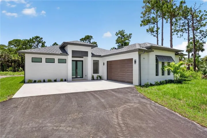 Contemporary white exterior with dark trim and a shingle roof