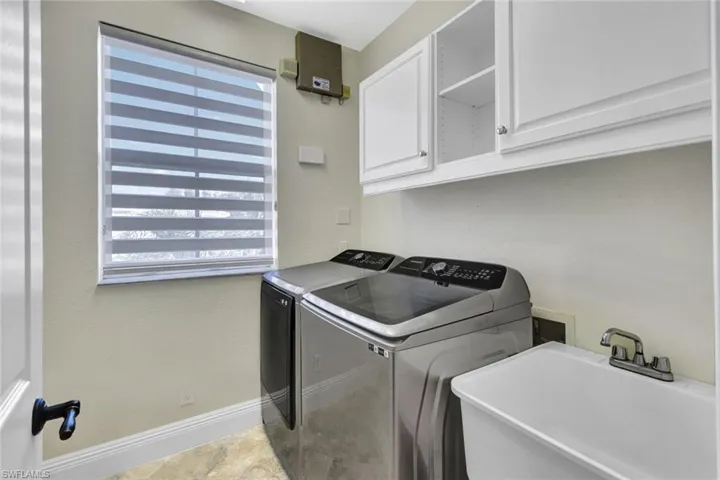 Laundry area featuring cabinet space and washer and dryer