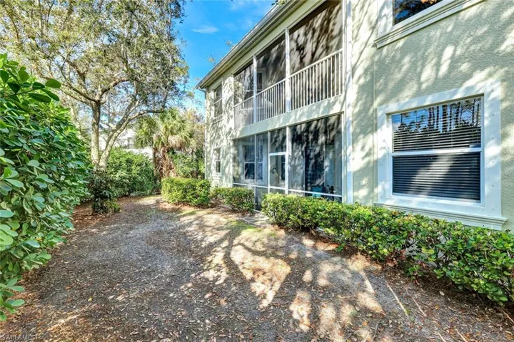 View of yard with a sunroom and a balcony