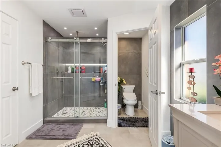 Bathroom featuring vanity and a shower stall