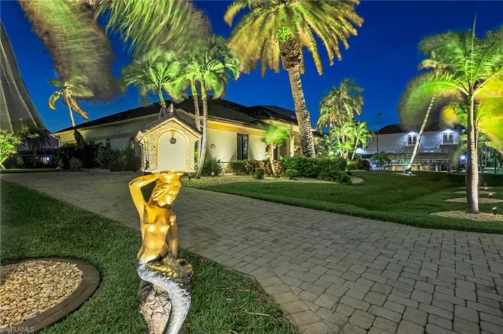 Custom lighting showcases the tropical landscape