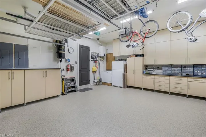 Huge garage with loads of cabinets.