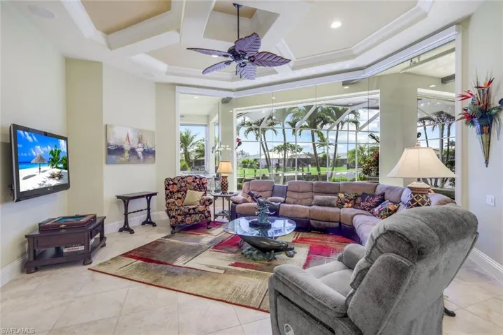 Open and bright living room waiting for your furnishings. You can help but notice the designer tray ceiling