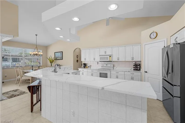 Very open to dining room and living room with vaults and breakfast counter.