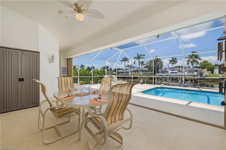 Outdoor dining area and pool access.