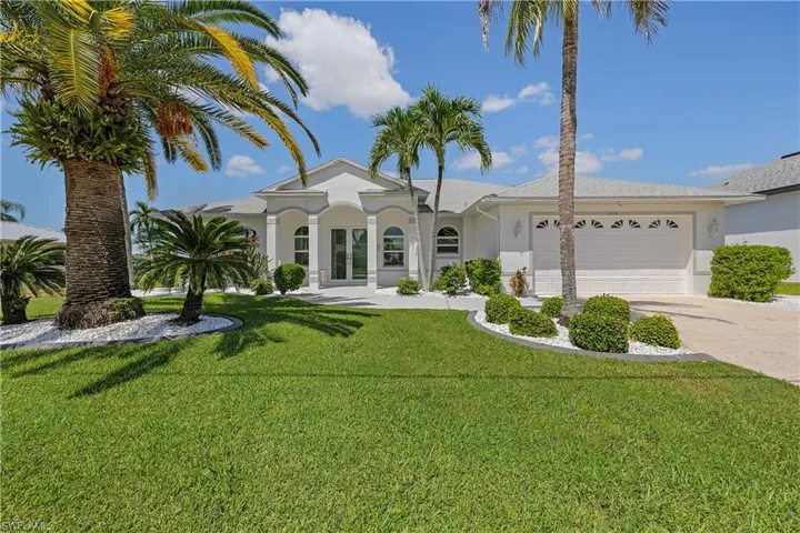 Freshly painted outside, beautiful palm trees adorn the property.