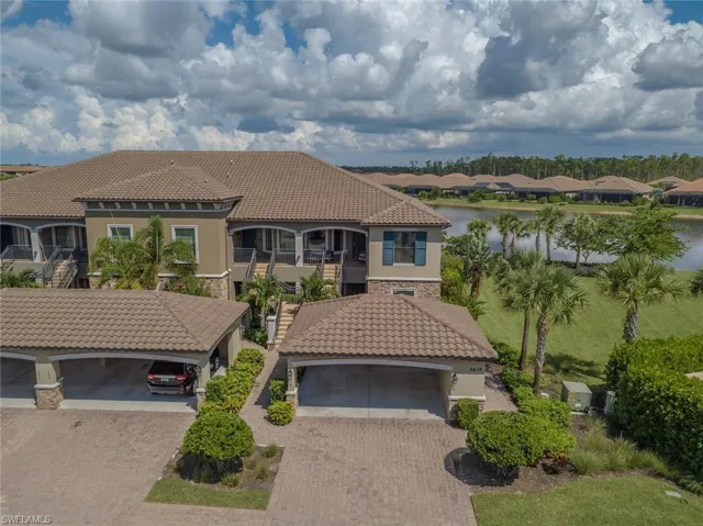 Mediterranean / spanish-style home featuring stone siding, stucco siding, a residential view, and a tile roof