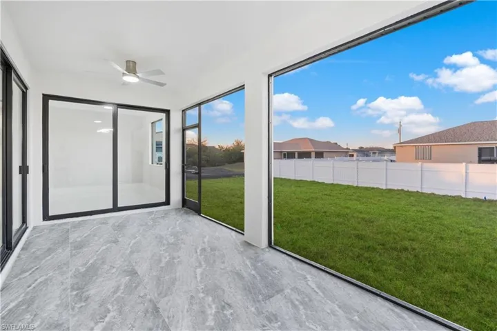 Unfurnished sunroom featuring ceiling fan