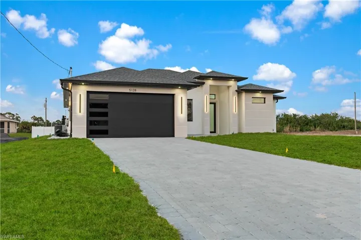 Prairie-style house with a garage and a front yard