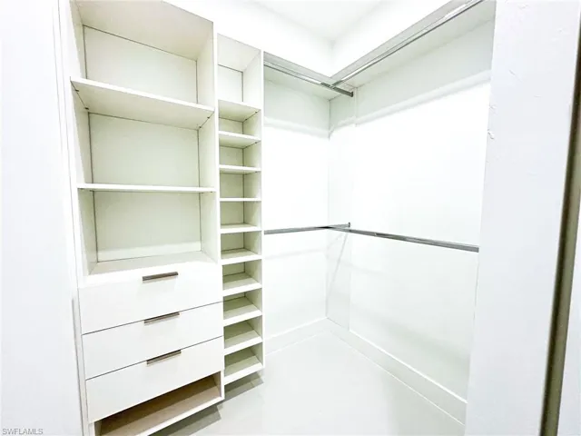 His and her walk in Closets in Master bedroom with real wood cabinets