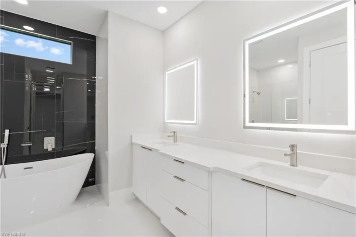 Bathroom featuring vanity and plus walk in shower