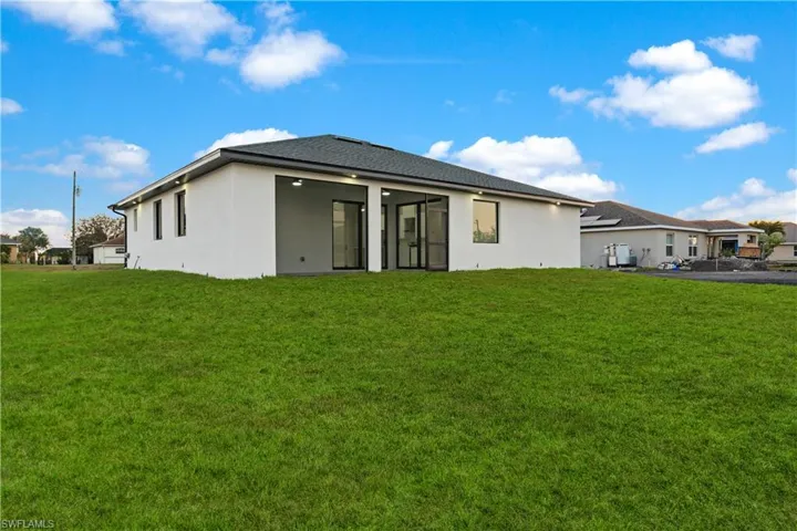 Rear view of house with a lawn