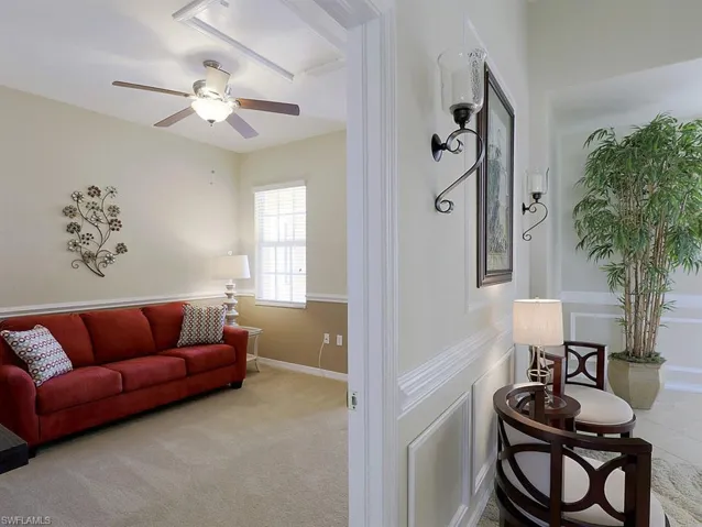 Living room featuring ceiling fan and light colored carpet