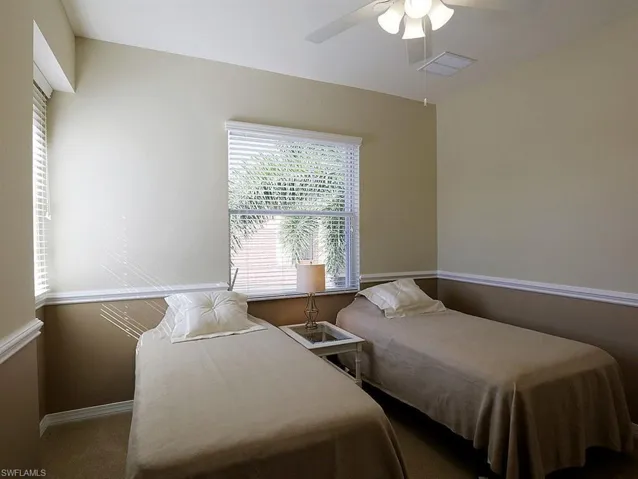 Bedroom with a ceiling fan and baseboards