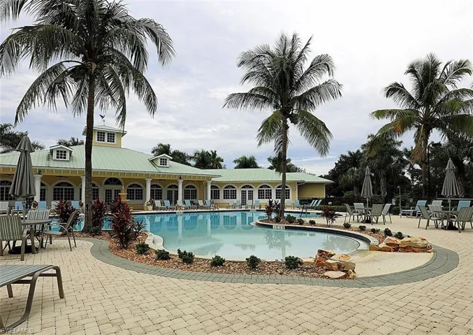 Community pool featuring a patio area and outdoor dining area