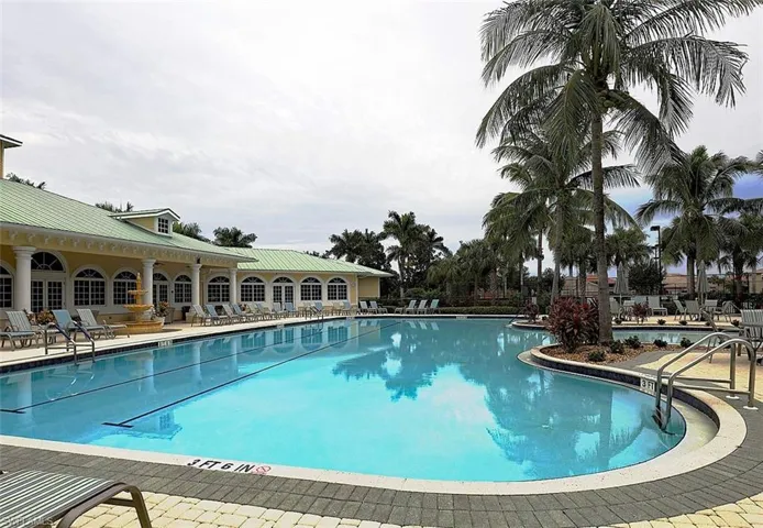 Community pool with a patio
