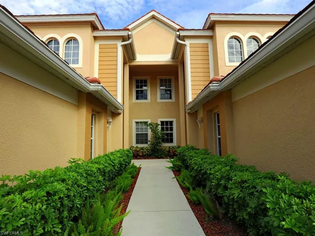 Doorway to property with stucco siding