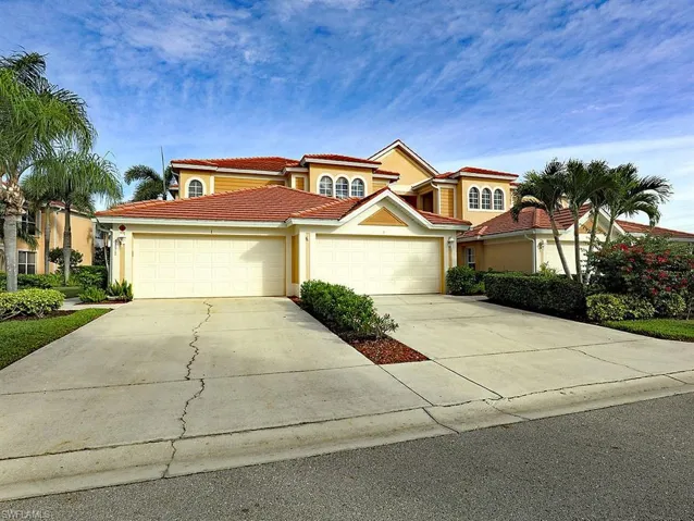 Mediterranean / spanish home with driveway, stucco siding, a garage, and a tiled roof