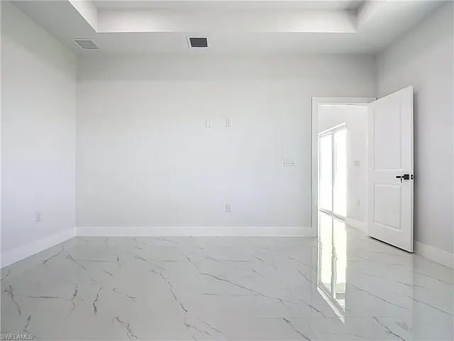 Empty room with light marble finish floors and baseboards