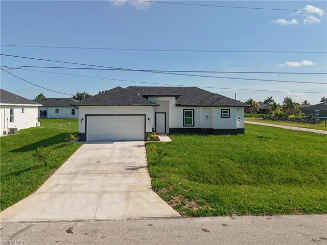View of front of property with stucco siding, concrete driveway, a garage, a front lawn, and roof with shingles
