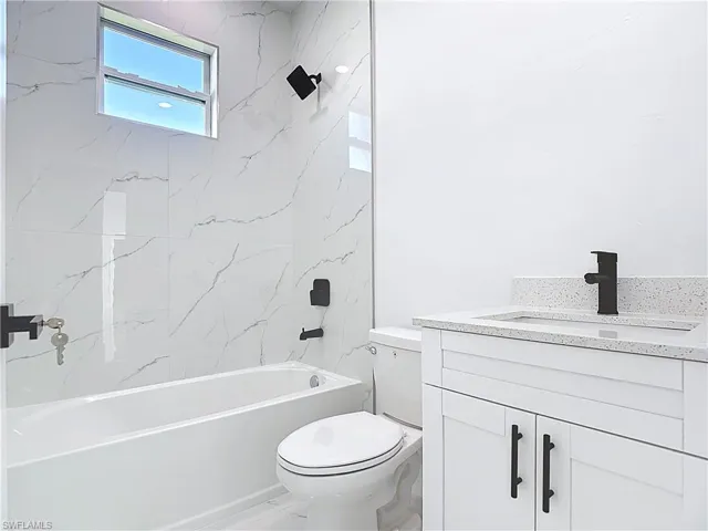 Bathroom featuring vanity and shower / bathtub combination