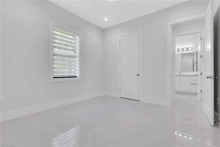 Unfurnished bedroom with recessed lighting and ensuite bathroom