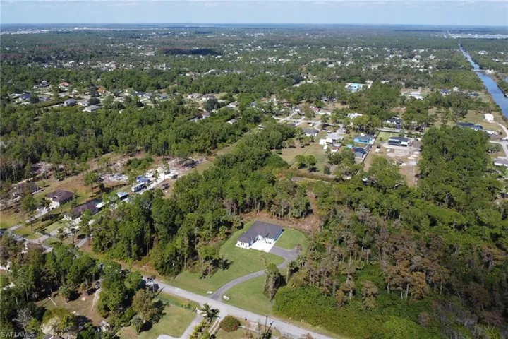 Aerial overview of property's location featuring nearby suburban area